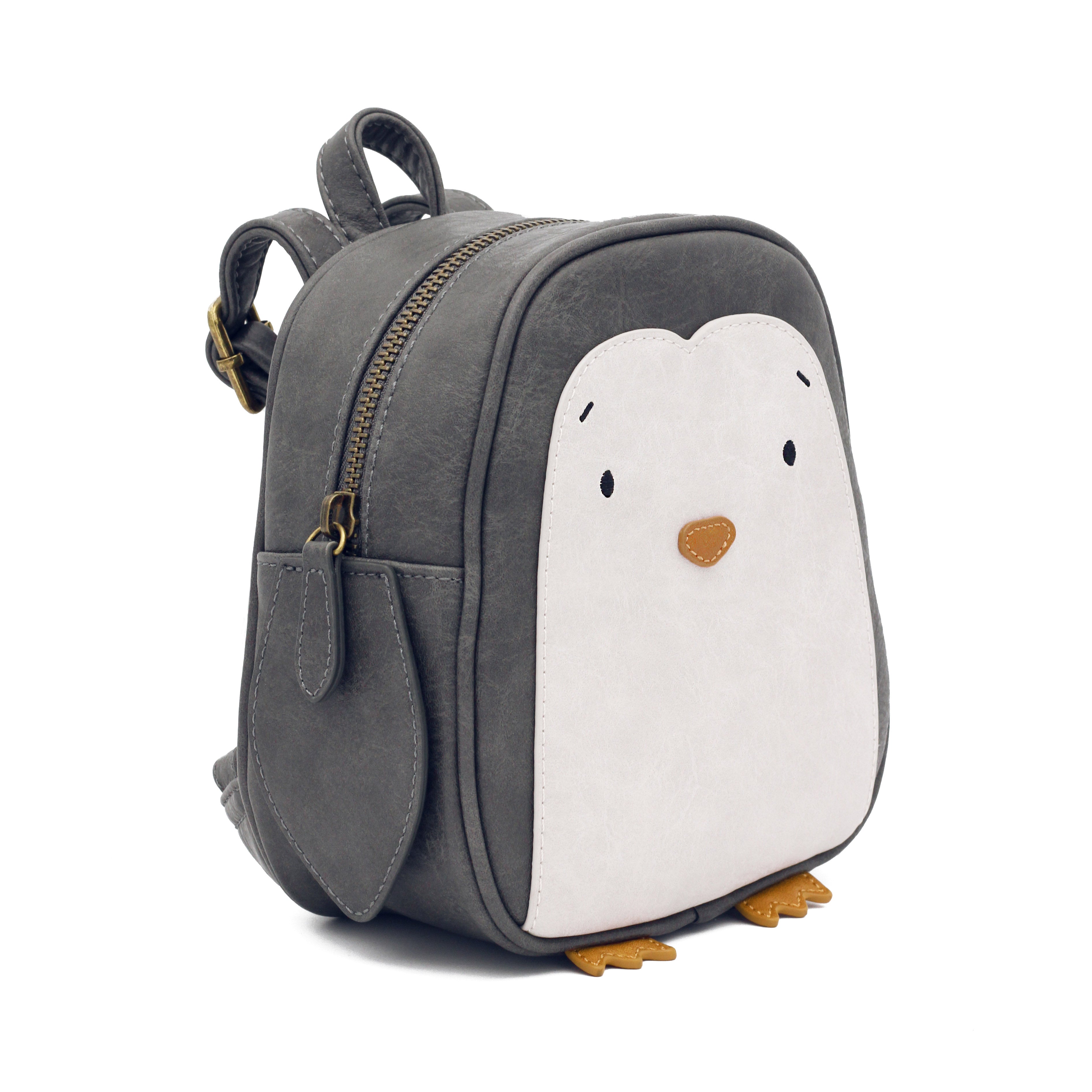 Ein kleiner, grauer Rucksack, der einem Pinguin ähnelt und in jedem Kinderartikelgeschäft erhältlich ist. Auf der Vorderseite befindet sich ein weiß-schwarzes Pinguingesicht mit winzigen Augen, einem orangefarbenen Schnabel und orangefarbenen Füßen an der Unterseite. Er hat ein Hauptfach mit Reißverschluss, Seitentaschen und wird mit spülmaschinenfesten Aufklebern zur einfachen Personalisierung geliefert. Wir präsentieren den Little Who - Rucksack Pinguin Lilo von Little Who.