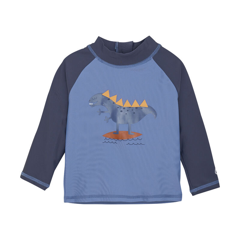 Ein Color Kids - UV-Shirt von Color Kids in Blau- und Grautönen. Auf der Vorderseite ist ein freundlicher Dinosaurier zu sehen, der auf einem orangefarbenen Surfbrett über blauen Wellen steht. Dieses UV-Schutz-Kleidung-Shirt hat einen hohen Kragen und dunkelgraue Ärmel, perfekte Kinderbademode für sonnige Strandtage.